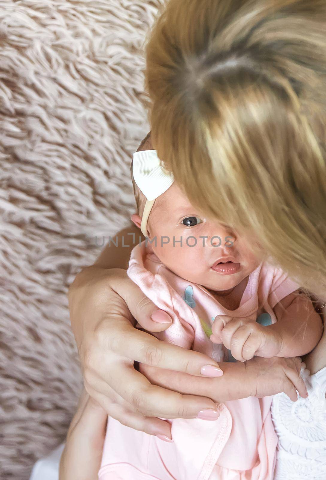 newborn baby in mother's arms. selective focus. people.
