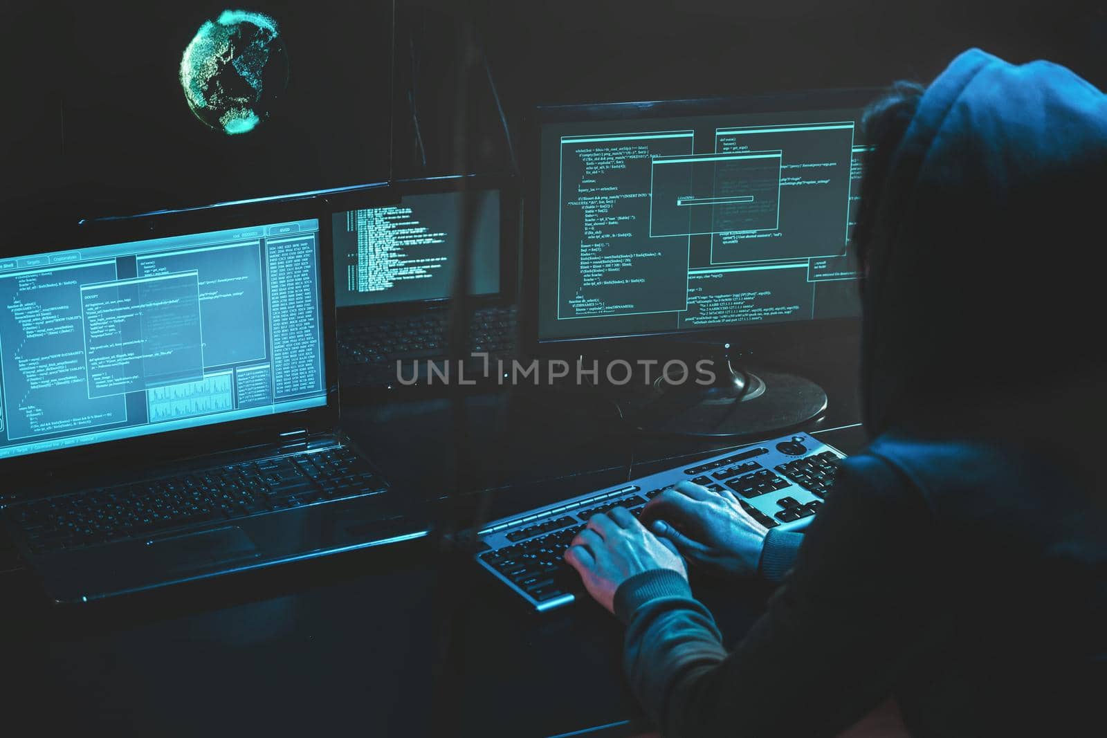Cyber criminal hacking system at monitors, hacker attack web servers in dark room at computer with monitors sending virus using email vulneraility. Internet crime, hacking and malware concept. Download image