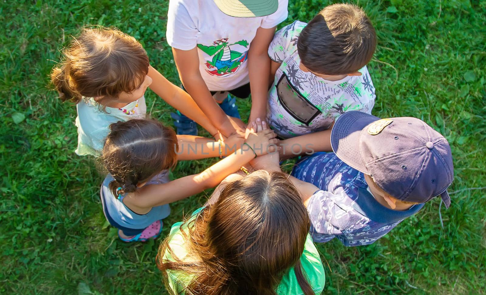 The children put their hands together. Selective focus. by yanadjana