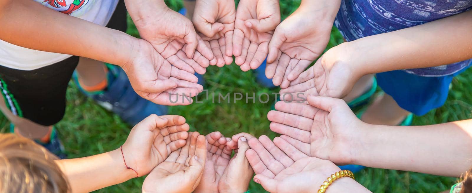 The children put their hands together. Selective focus. people.