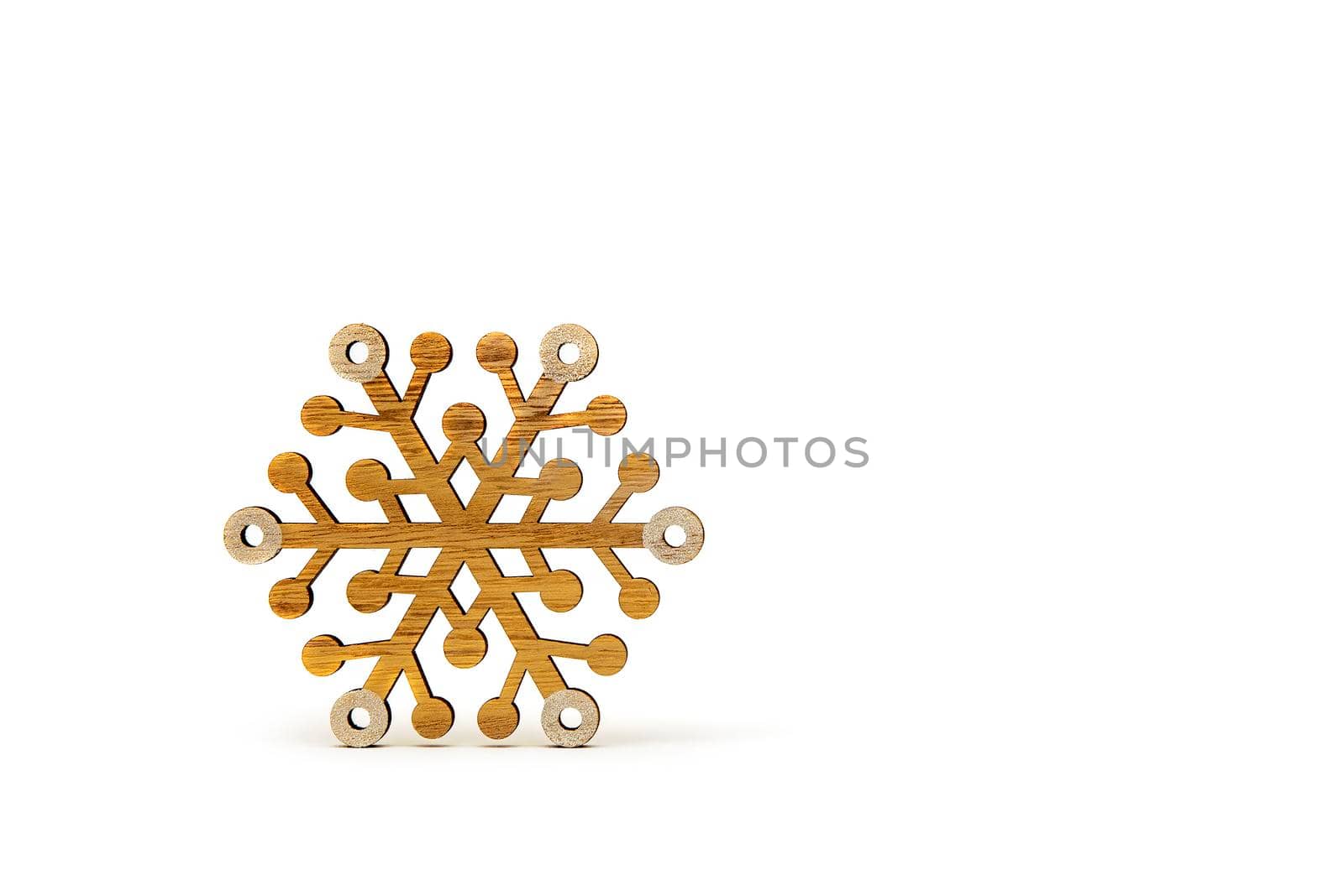 Snowflake on a white background. Wooden snowflakes cast shadow on white isolated background. Printable banner, mockup for christmas card, place for text.