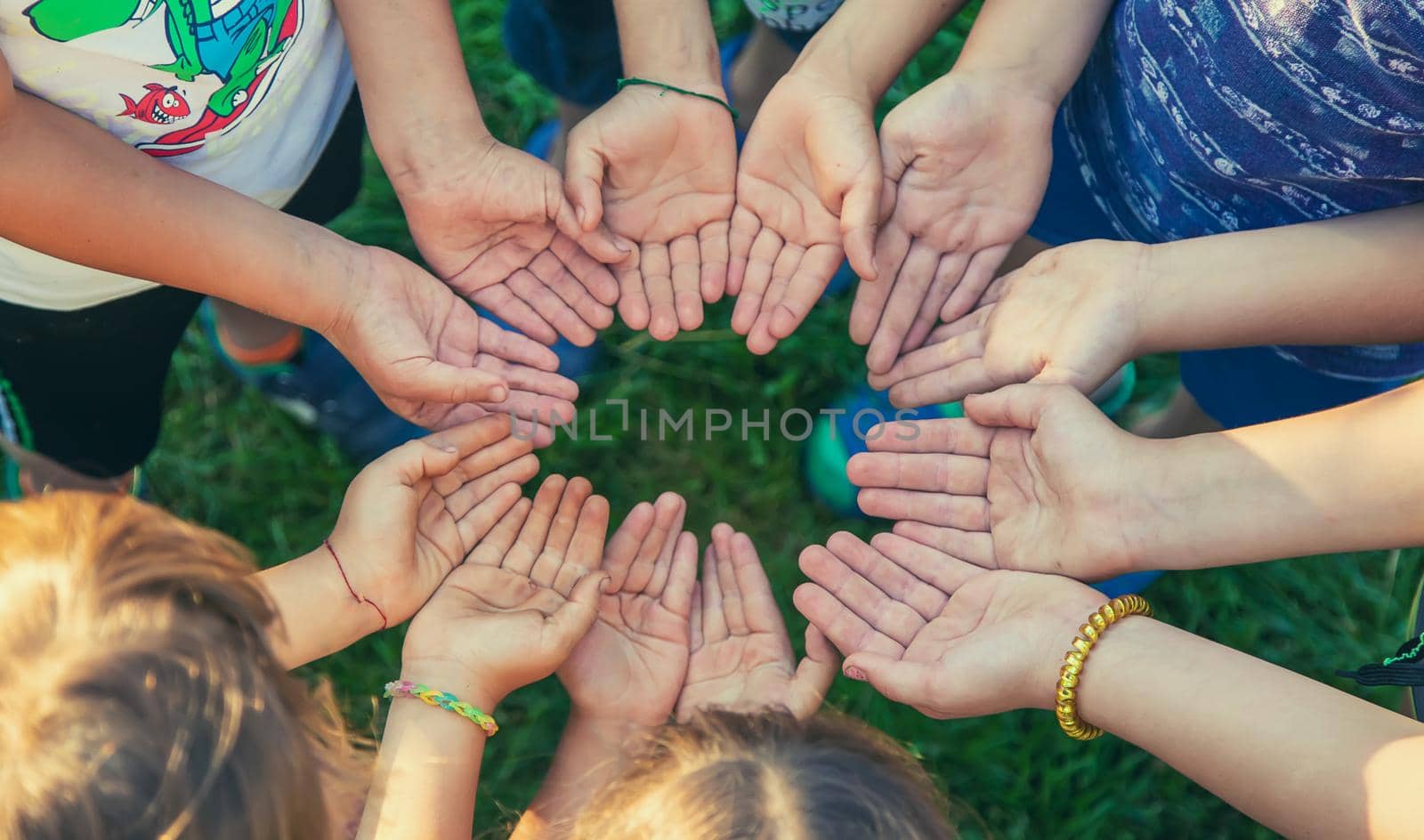 The children put their hands together. Selective focus. people.