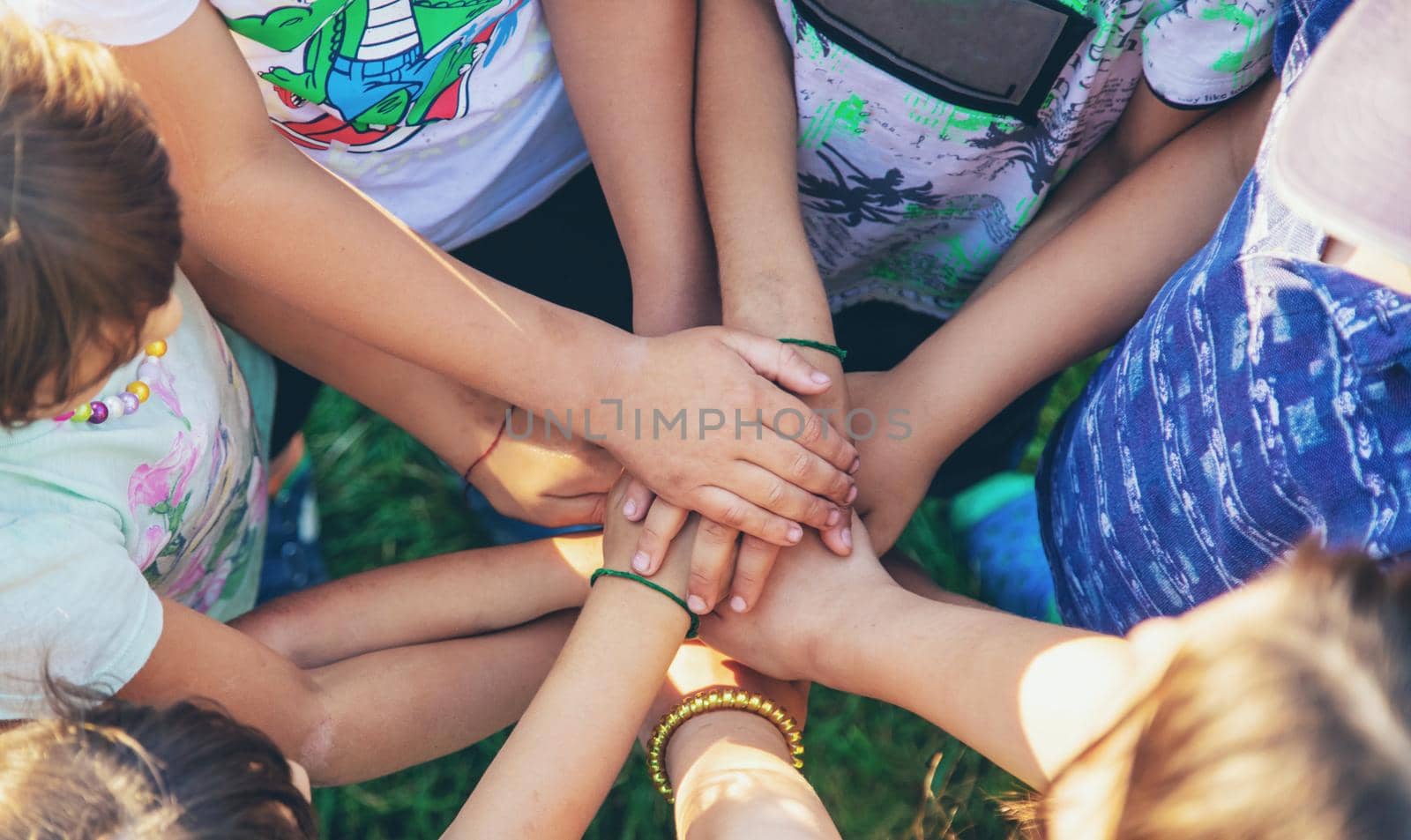 The children put their hands together. Selective focus. people.