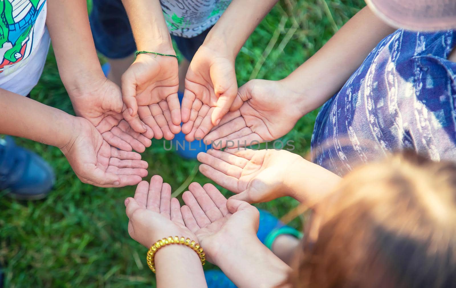 The children put their hands together. Selective focus. people.