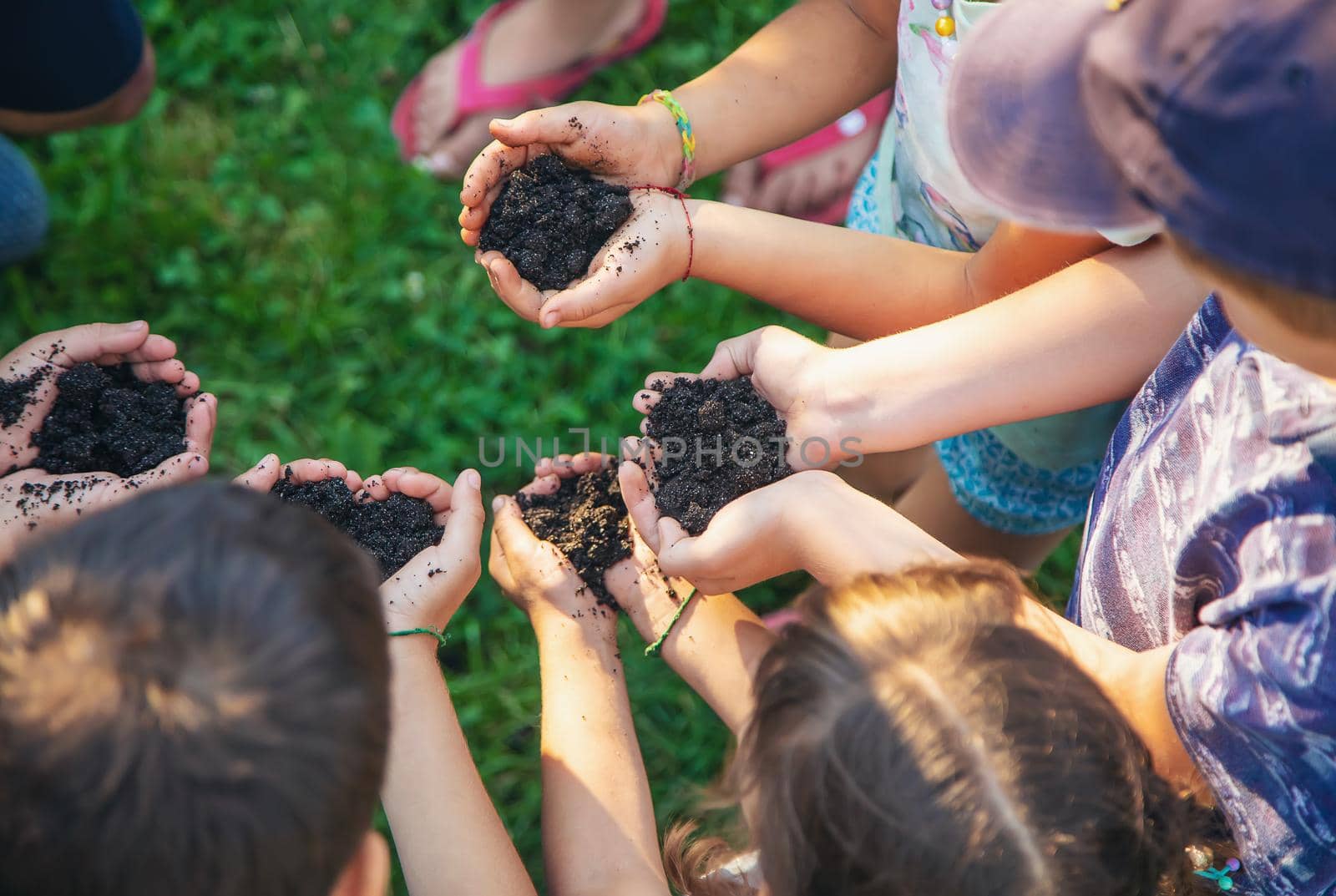Children hold the earth in their hands. Selective focus. by yanadjana