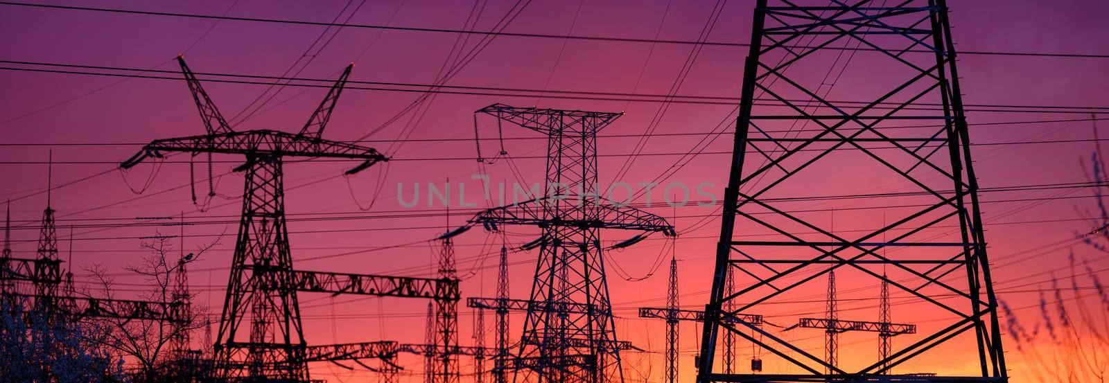 View of high voltage pole power transmission tower on sunset. Panorama high voltage tower with power lines. Download high quality photo