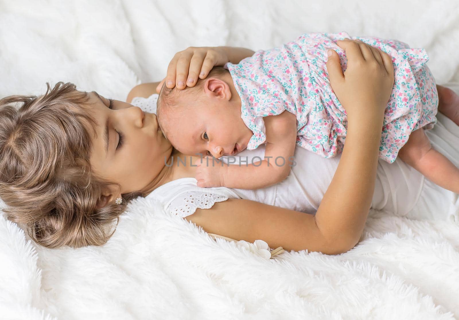 newborn toddler with older sister. selective focus. by yanadjana