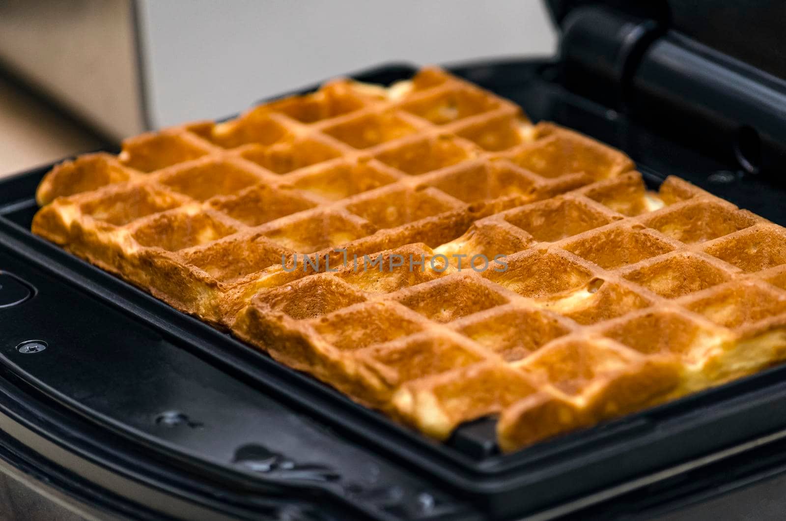The process of making waffles. Belgian waffles cooking process.