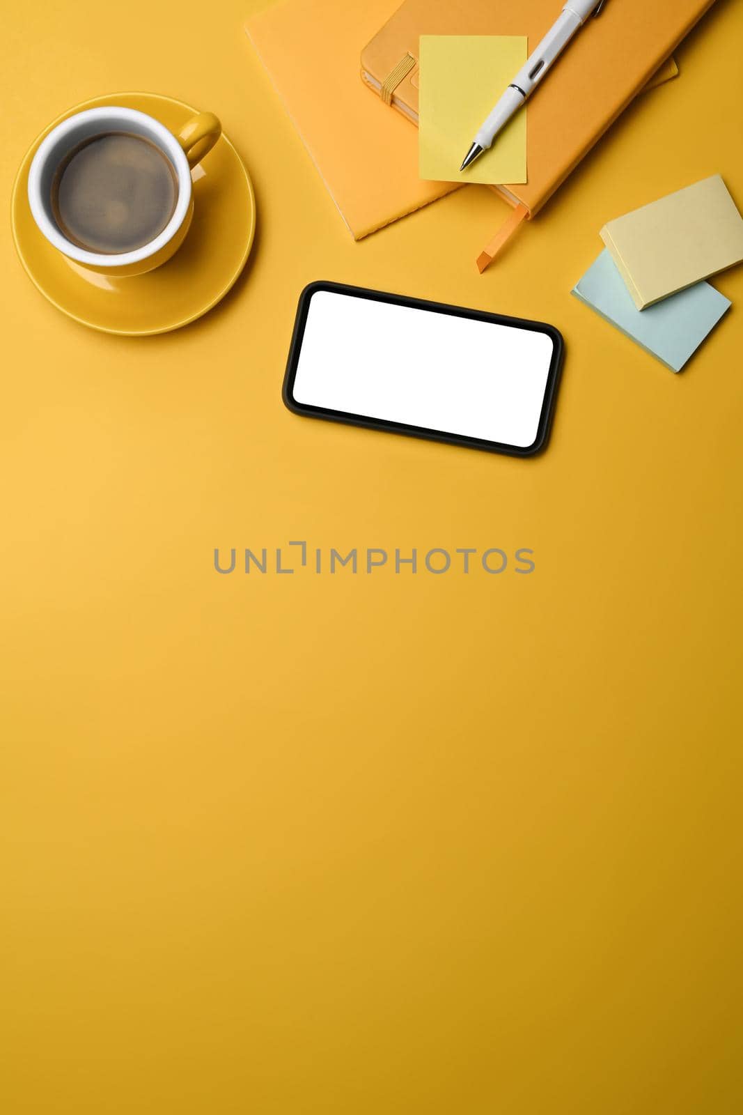 Top view smart phone with blank screen on yellow background. Copy space. by prathanchorruangsak