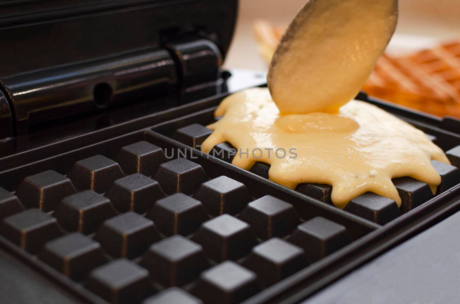 Modern waffle maker with ingredients, homemade Belgian waffles.