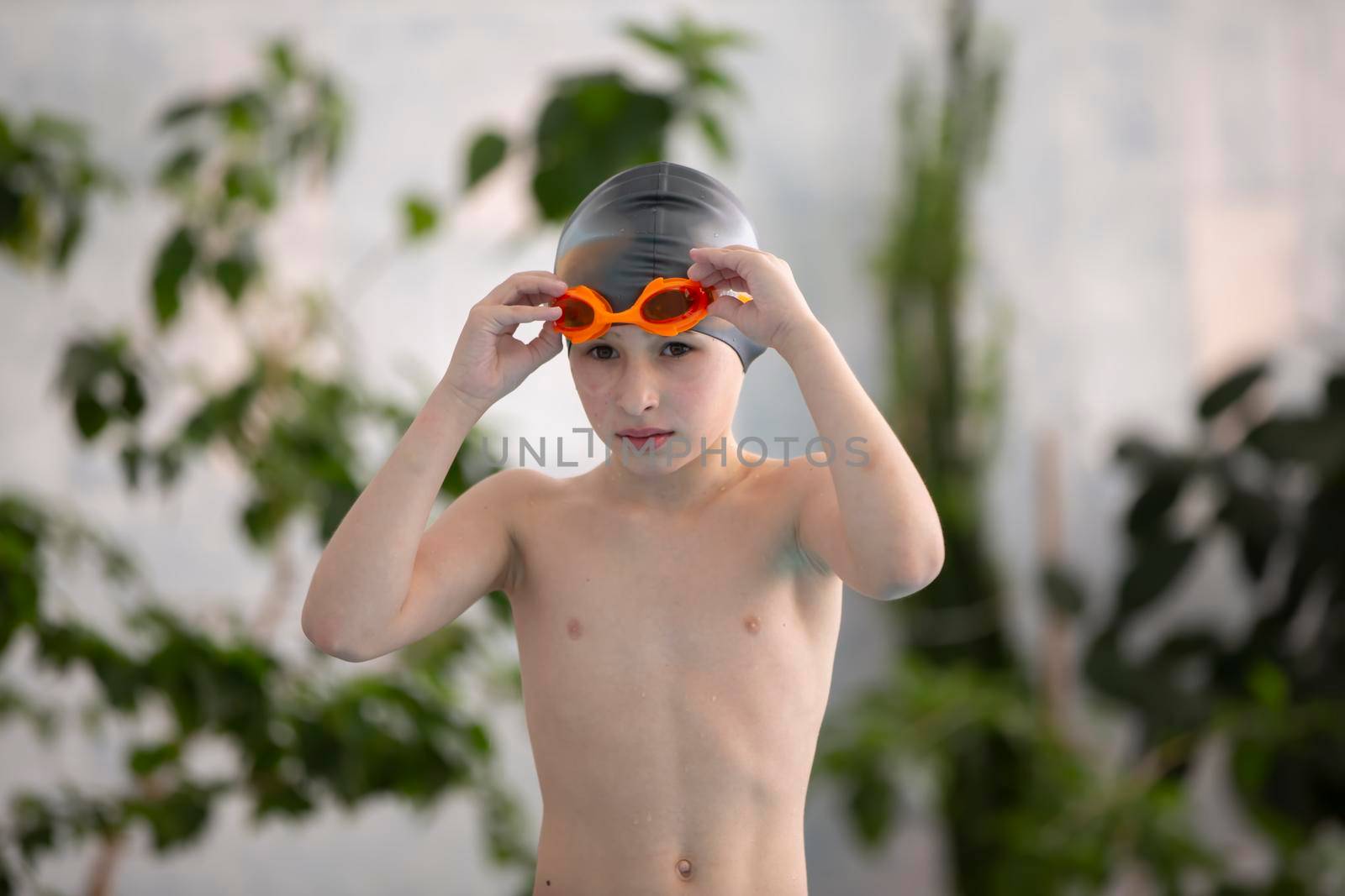 Boy in a swimming cap in the sports pool.