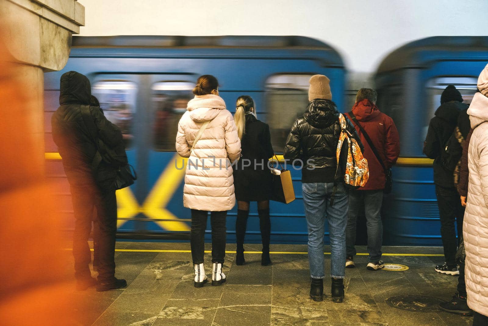 Subway station in KievVarious people stand at metro station,waiting for their train to ride-web,city life scene,social story concept. Subway station in Kiev. download photo