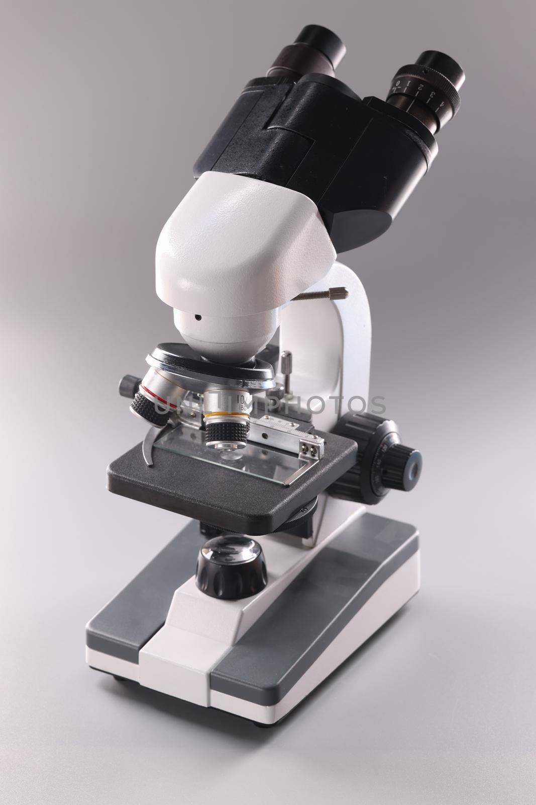 Microscope on gray background Microbiology and healthcare by kuprevich