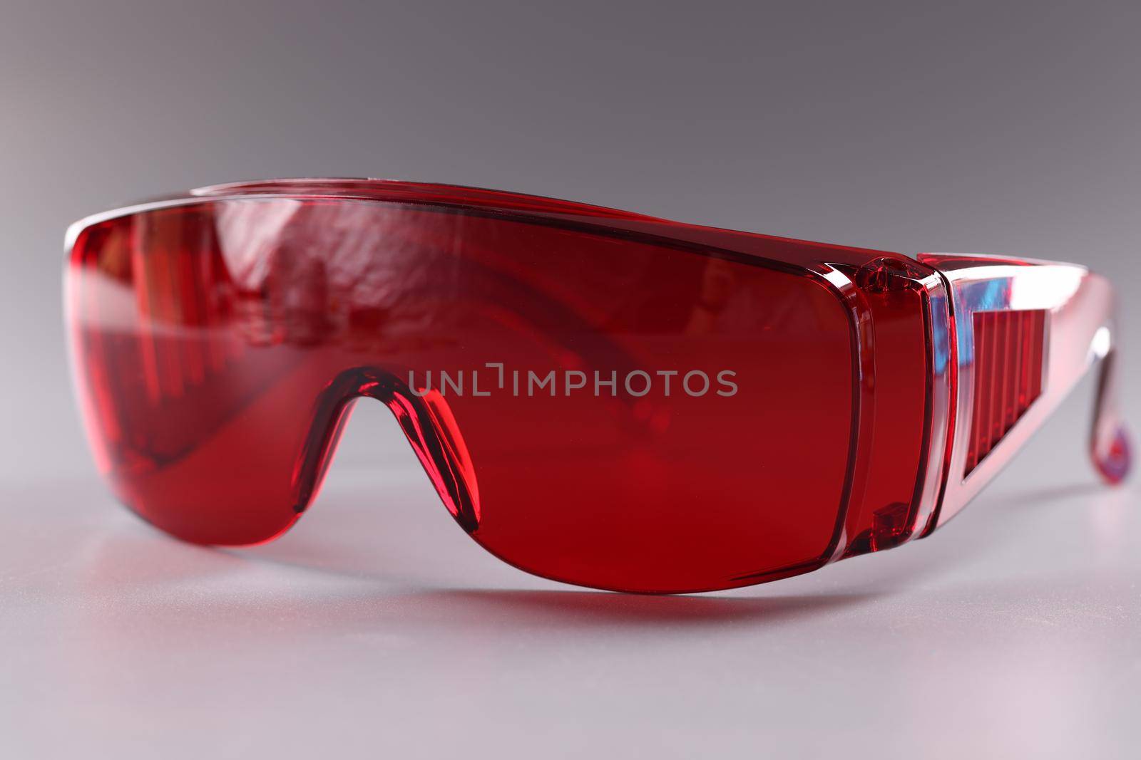 UV protective goggles on gray background. Laser eye protection by kuprevich