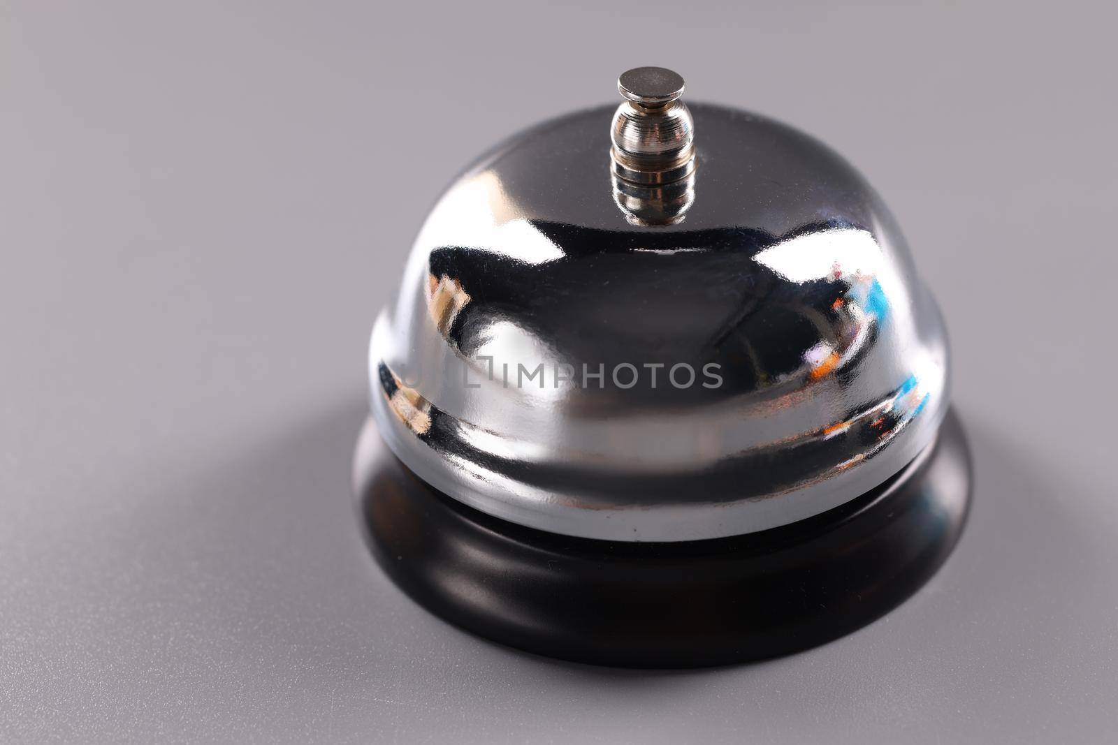 Silver vintage ringing bell on gray background. Ringing bell at the hotel reception and guest area concept