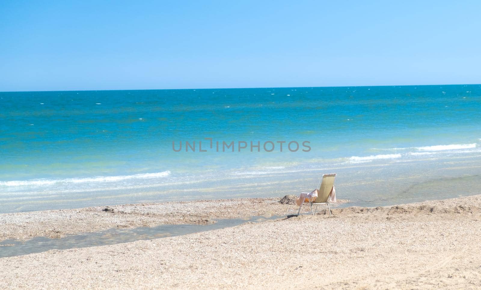 empty chair on the beach. Beach with blue sky and sea as vacation concept by igor010