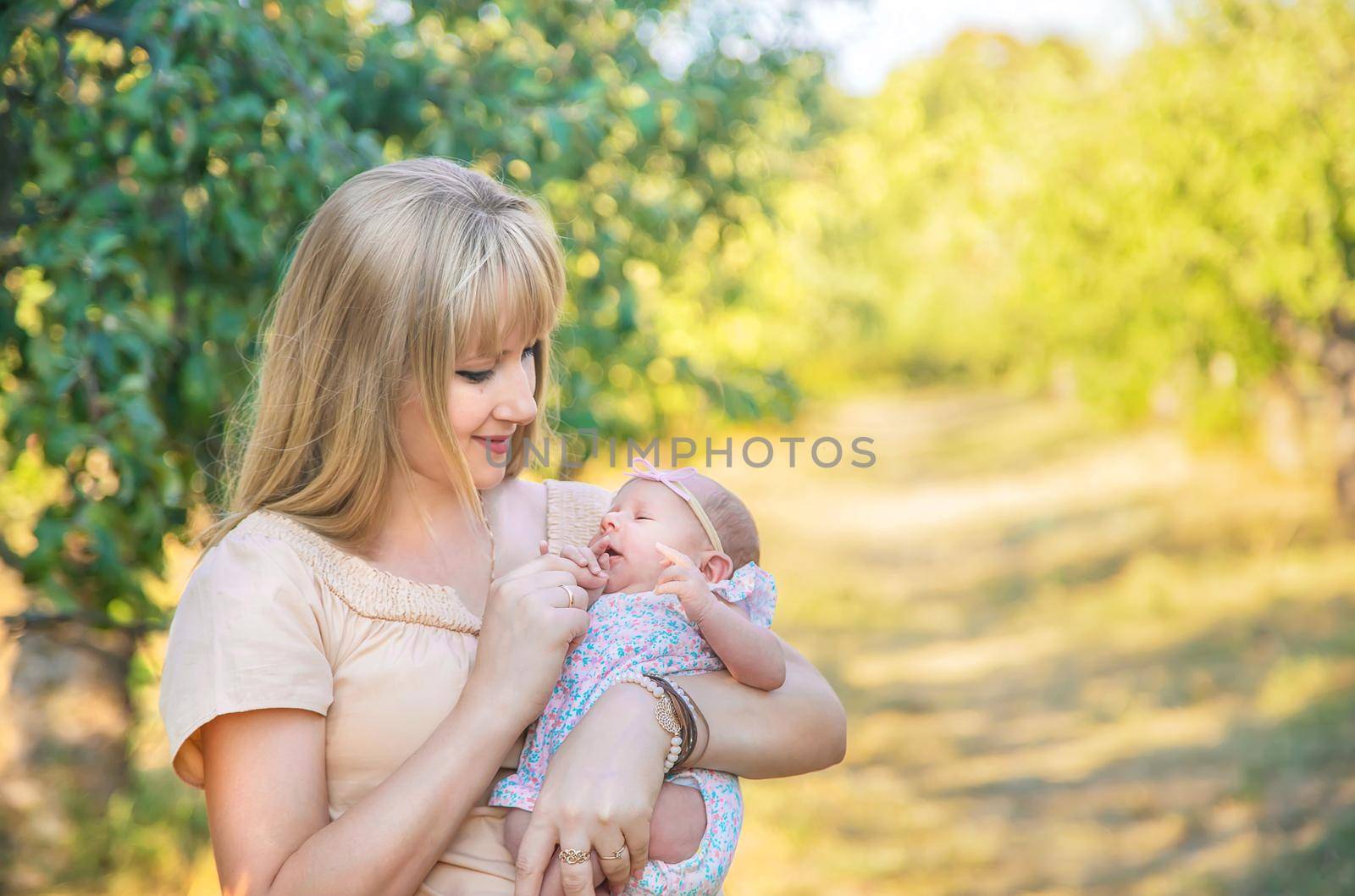 Mom with a newborn baby in her arms. Selective focus. People.