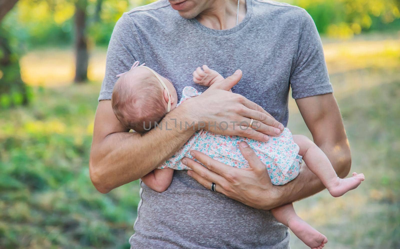 Father with his newborn daughter in his arms. Selective focus. by yanadjana