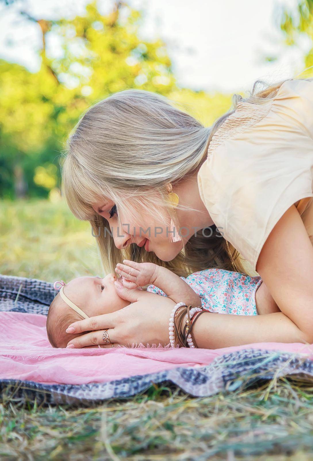 Mom with a newborn baby in her arms. Selective focus. by yanadjana