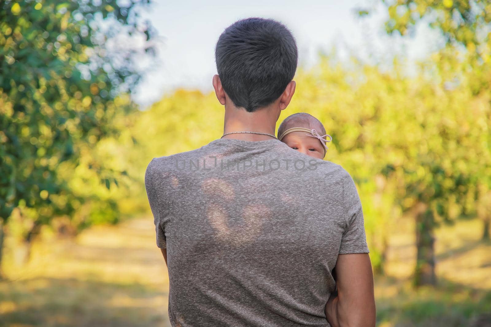 Father with his newborn daughter in his arms. Selective focus. by yanadjana