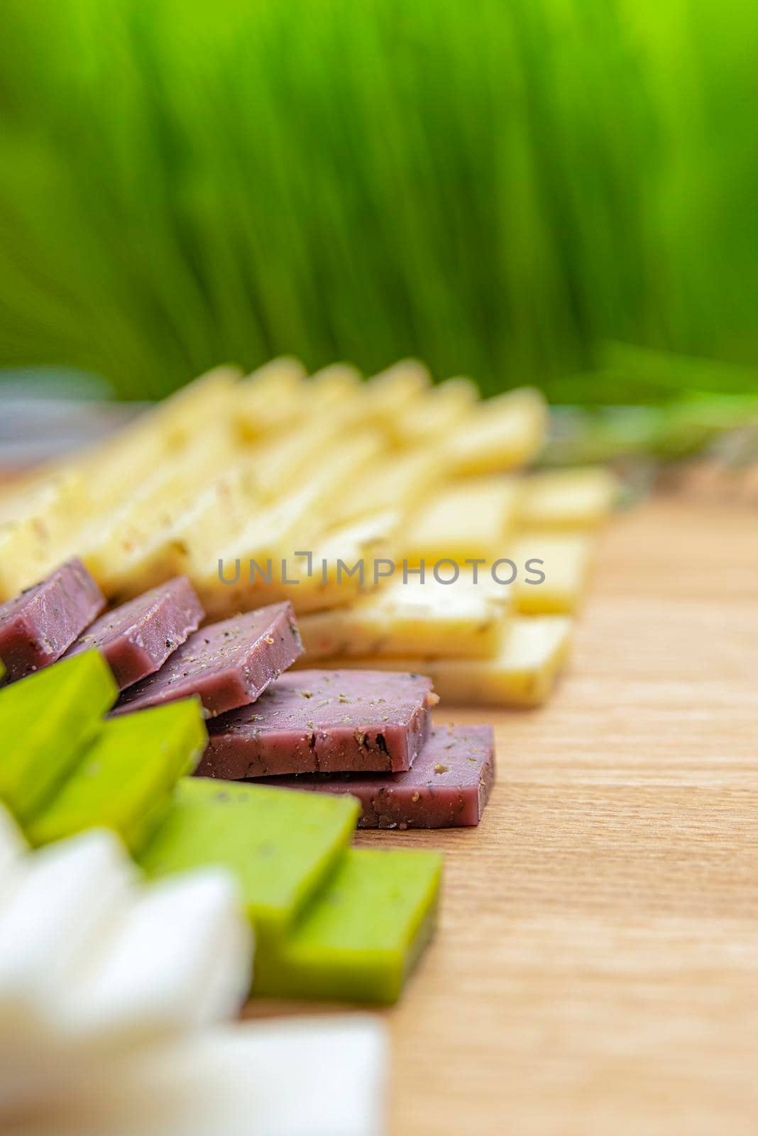 Cheese background. Assortment of different types of cheese on a wooden background.Place for text by SERSOL