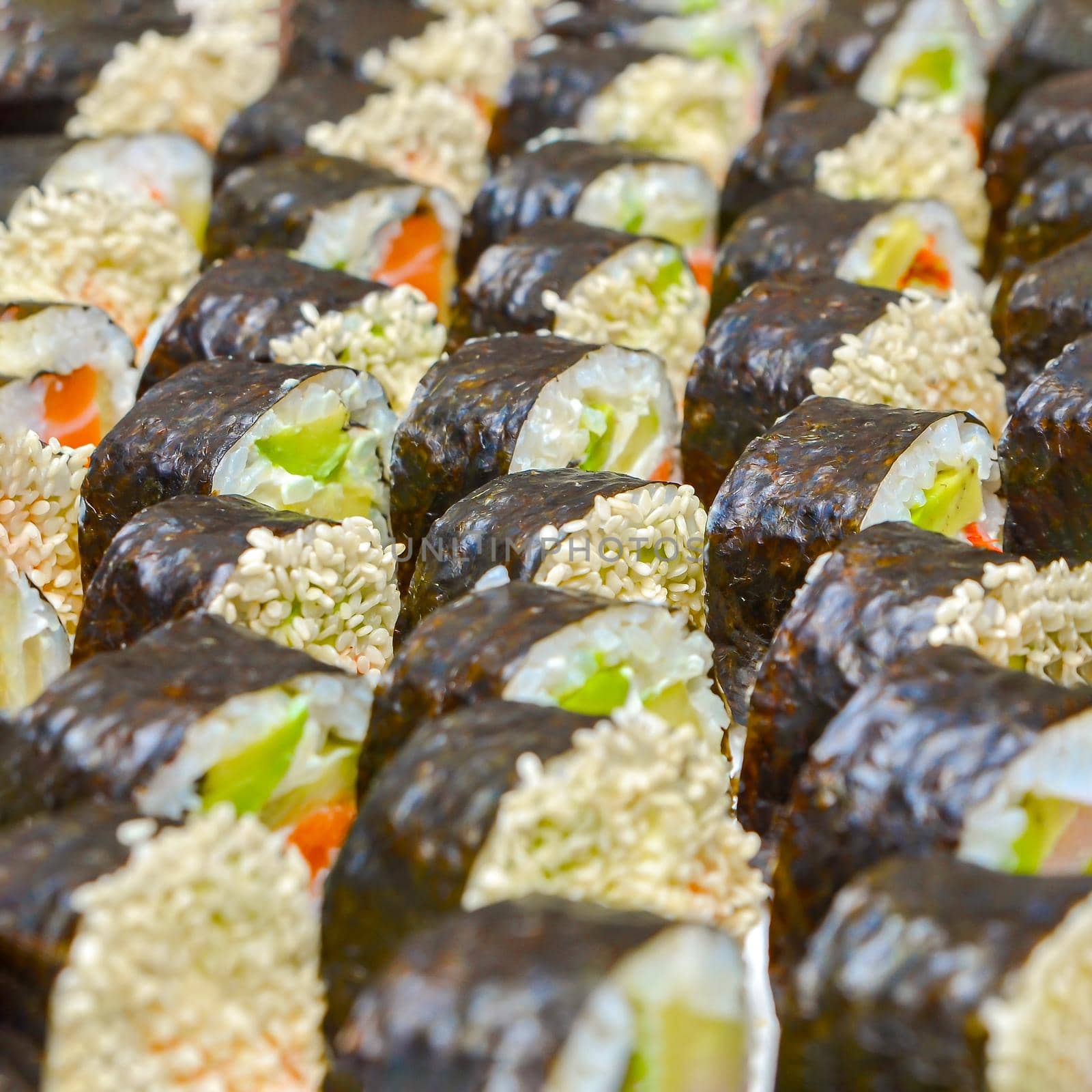 Fresh delicious Japanese sushi with avocado, cucumber, shrimps, close-up. by SERSOL