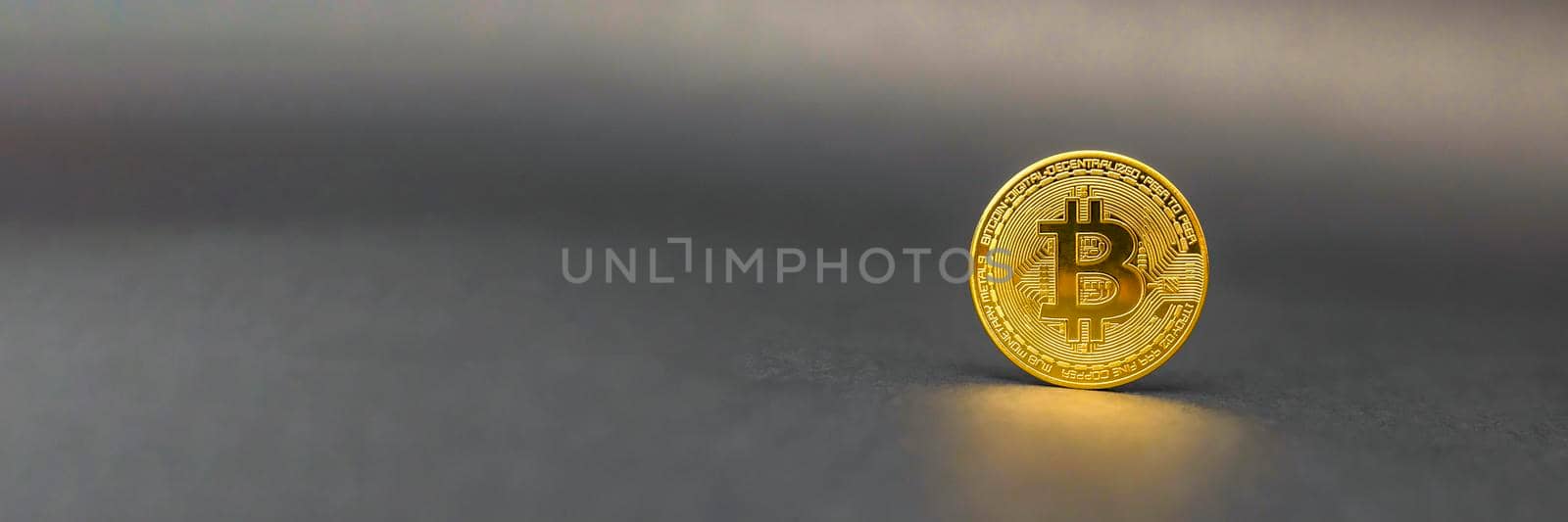 Bitcoin symbol in gold color on a black background. The concept of crypto currencies as the future of the economy