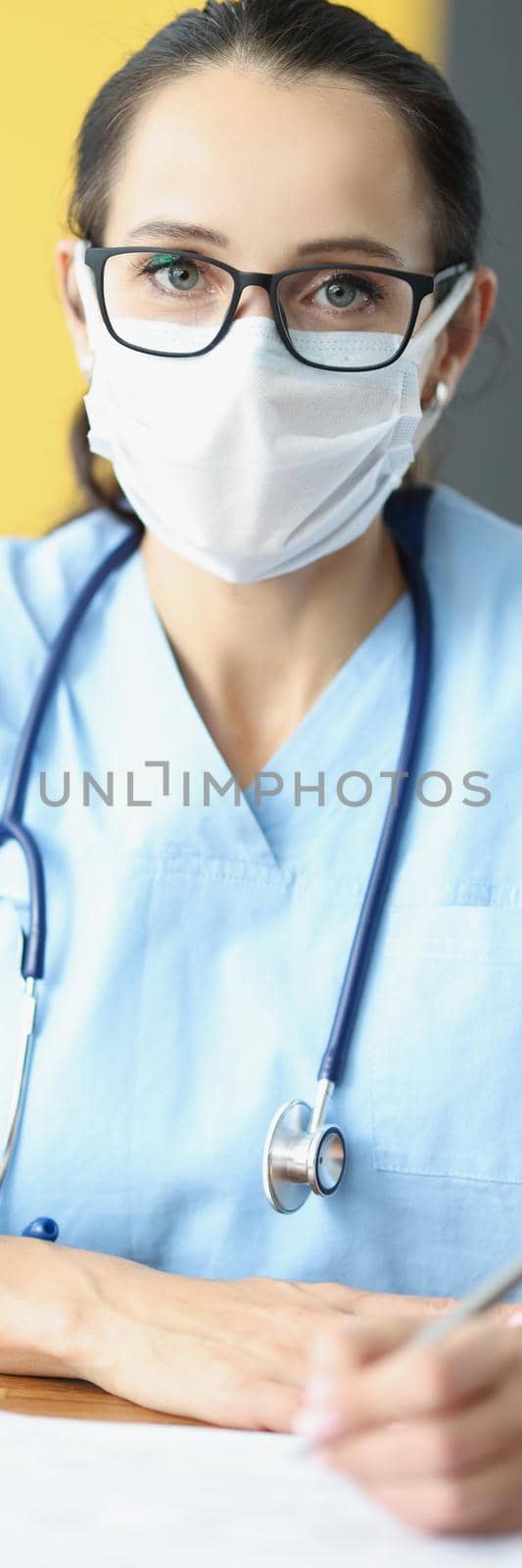 Portrait of qualified doctor ready to listen to patient, appointment in office, woman in uniform and face mask with stethoscope. Hospital, medical worker, clinic, healthcare, checkup concept