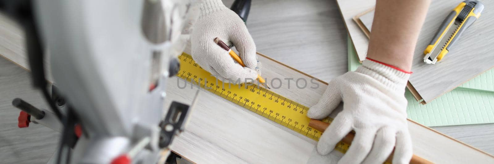 Top view of professional worker drawing line for cutting, ruler and pencil tools. Foreman perform construction task, renovation in apartment. Redecoration, fix furniture concept