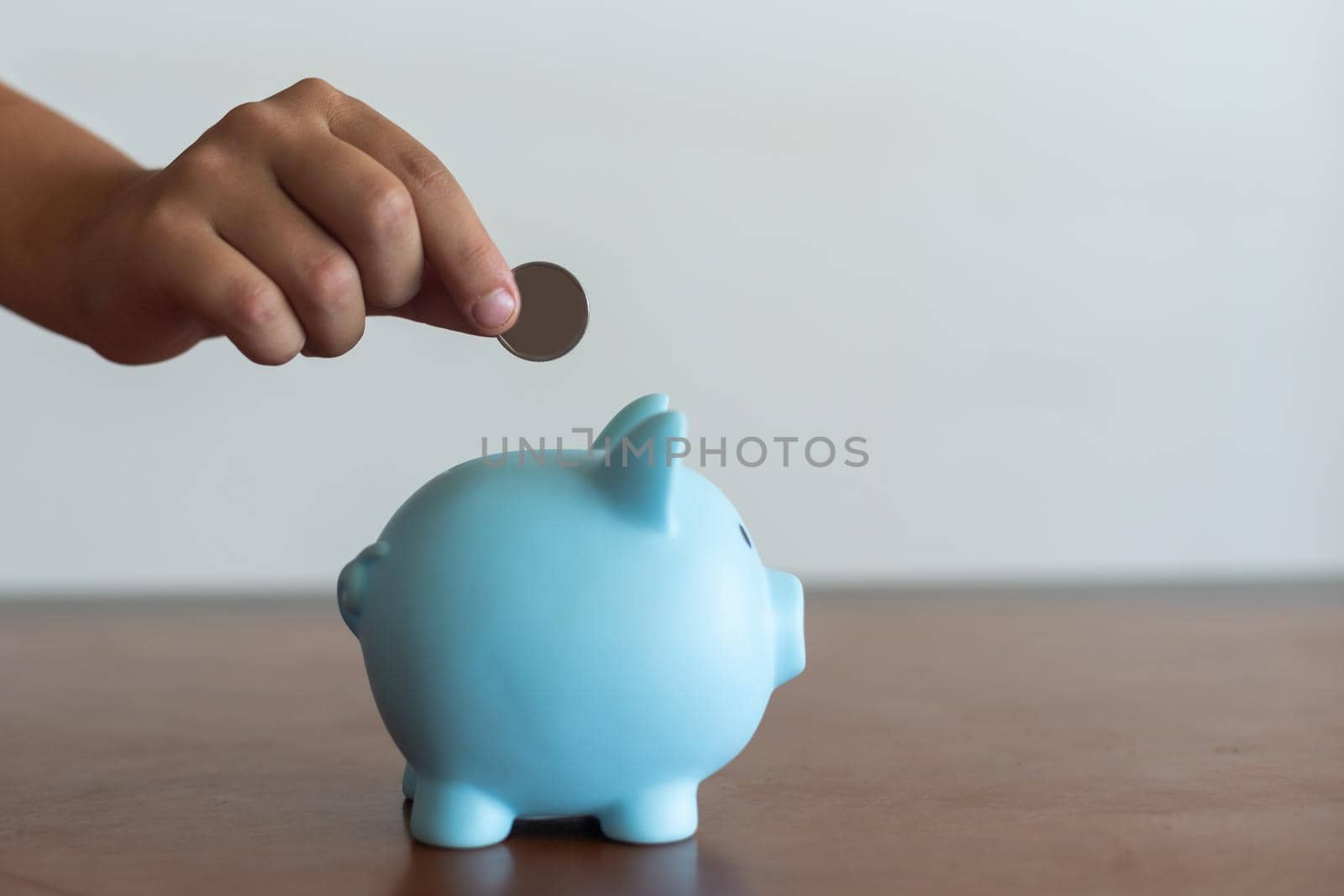 Pink piggy bank in the children's hands.