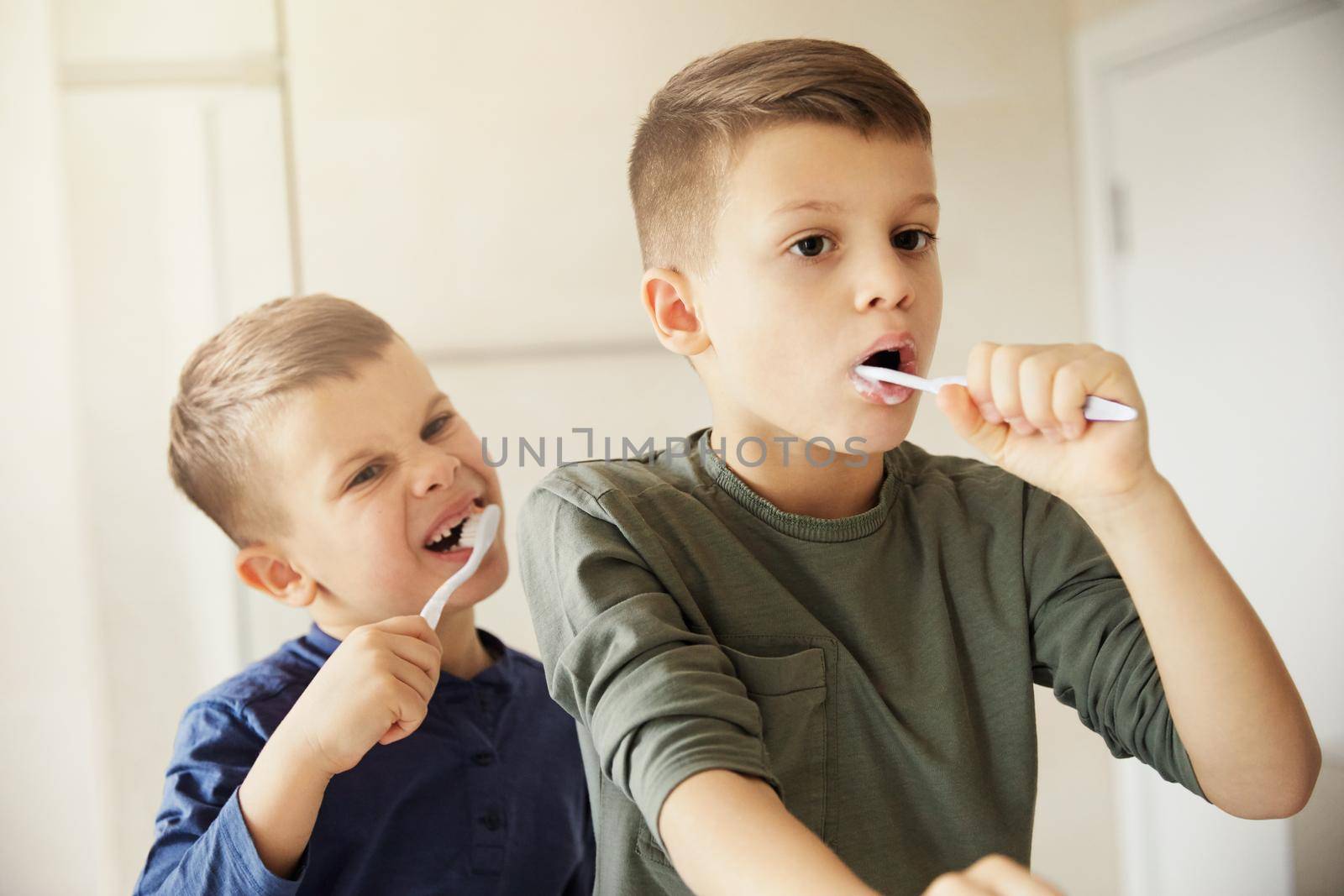 boy brushing teeth dental toothbrush daily habit routine child hygiene health care brother brush bathroom by Picsfive