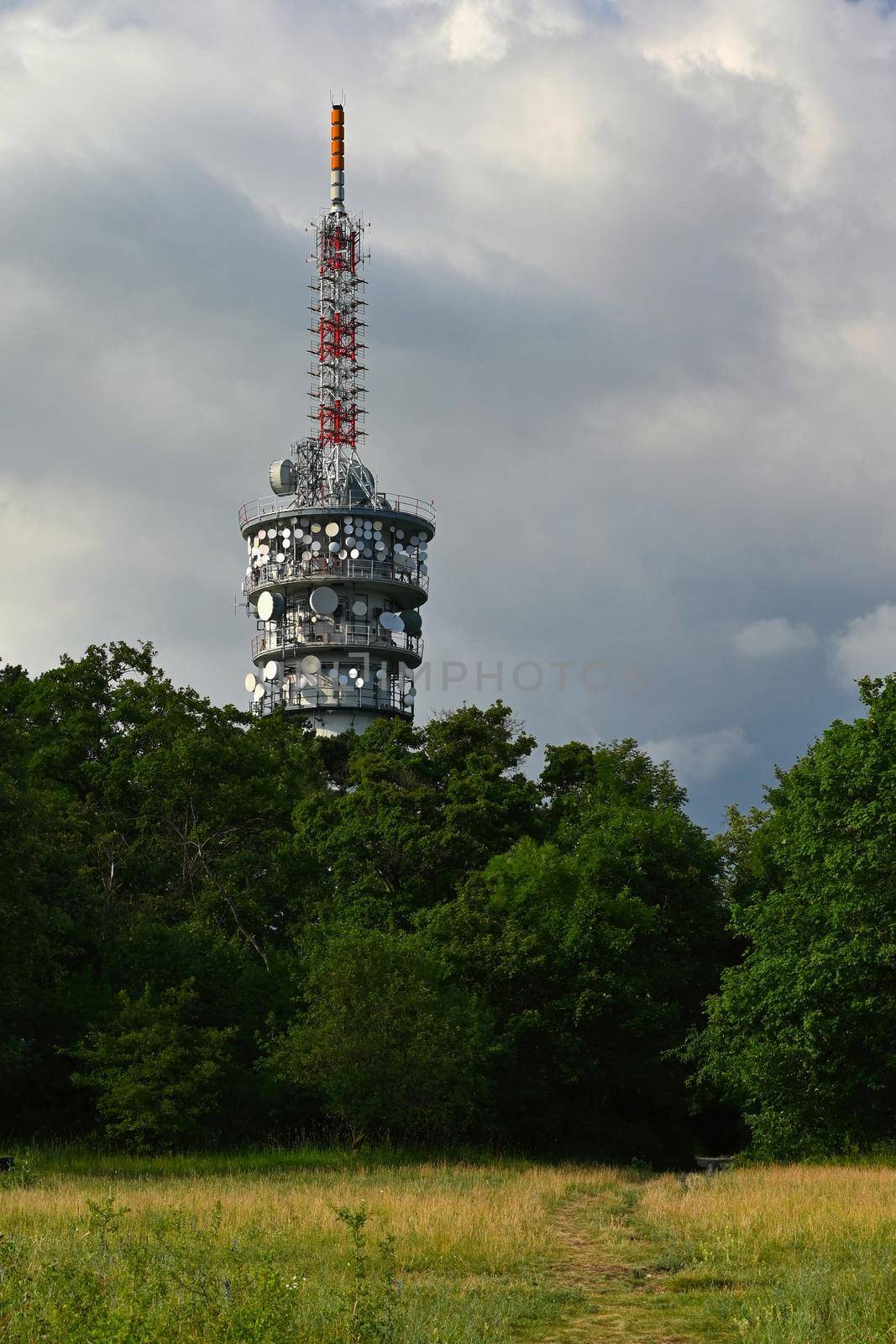 Large TV transmitter with satellite dishes and other antennas. Internet - wifi - mobile gsm signal. Concept for technology and industry. Brno - Hady.