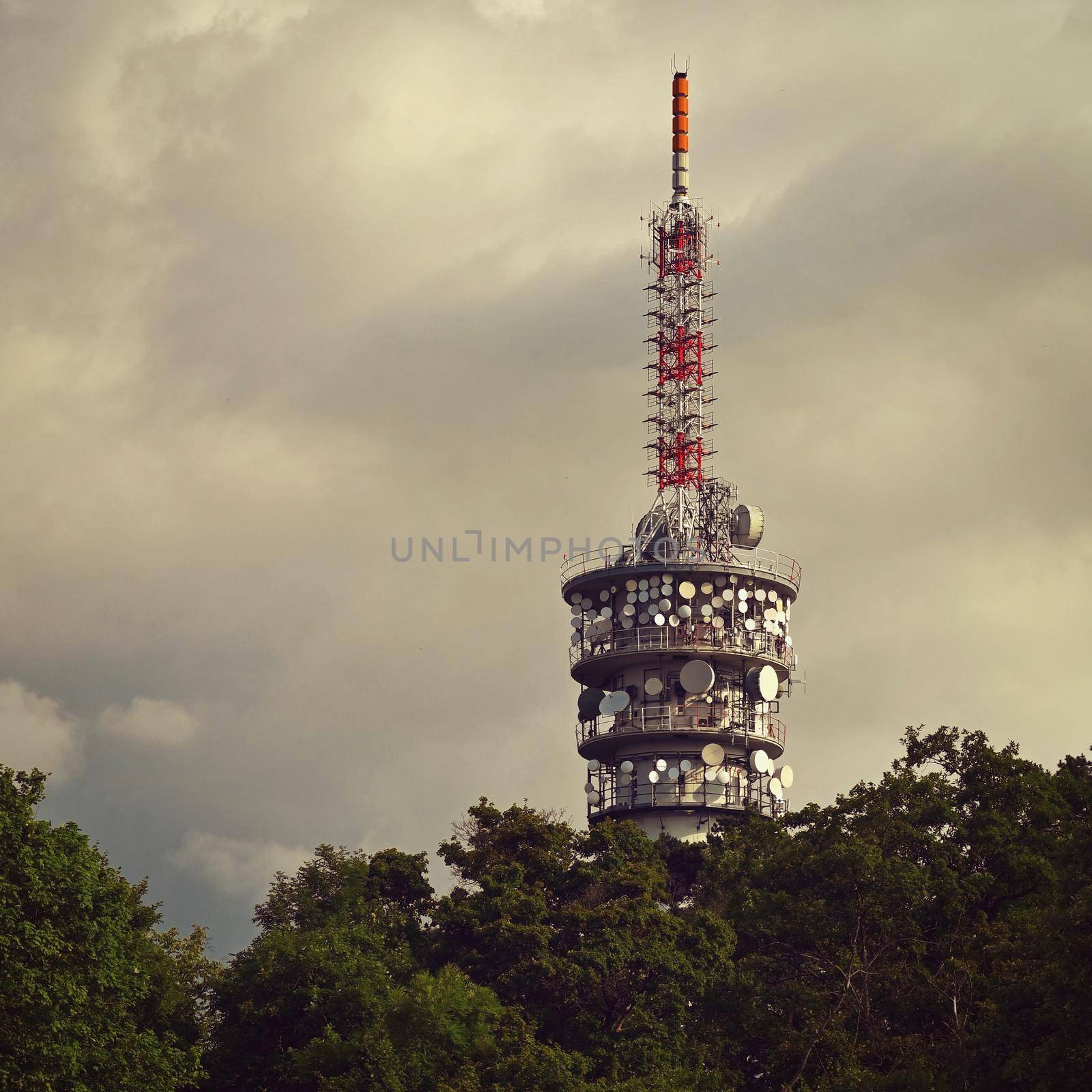 Large TV transmitter with satellite dishes and other antennas. Internet - wifi - mobile gsm signal. Concept for technology and industry. Brno - Hady.