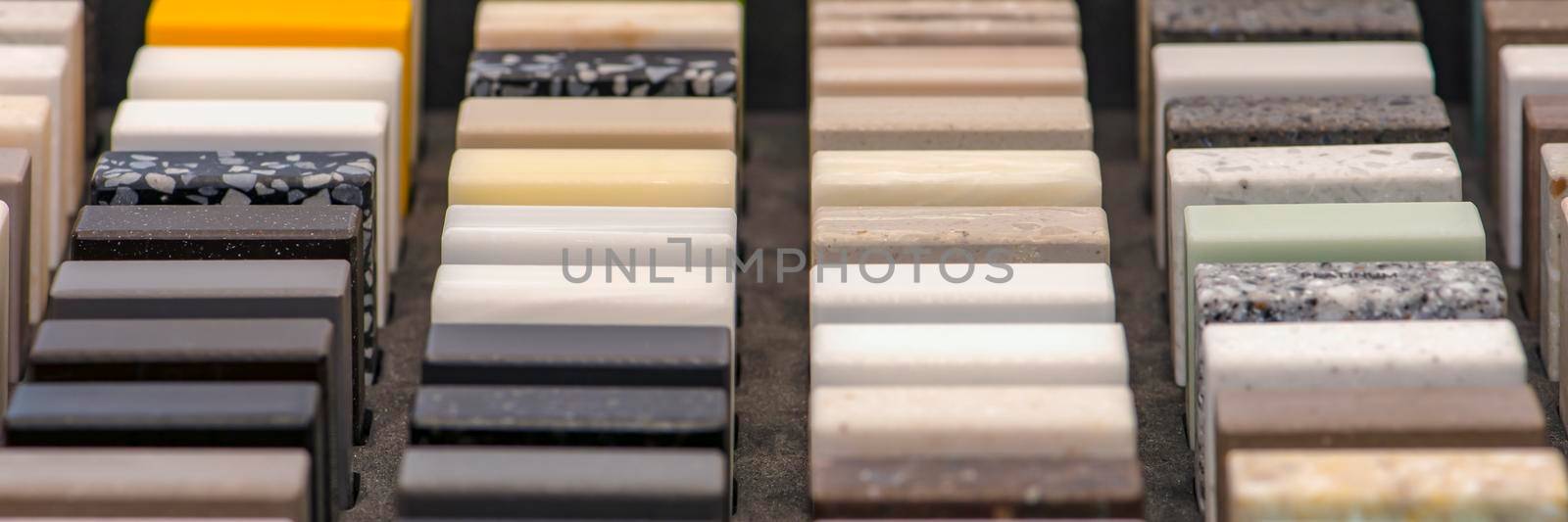 Samples of decorative artificial stone, close-up. Stone samples for kitchen countertops or bathroom, modern interior design.