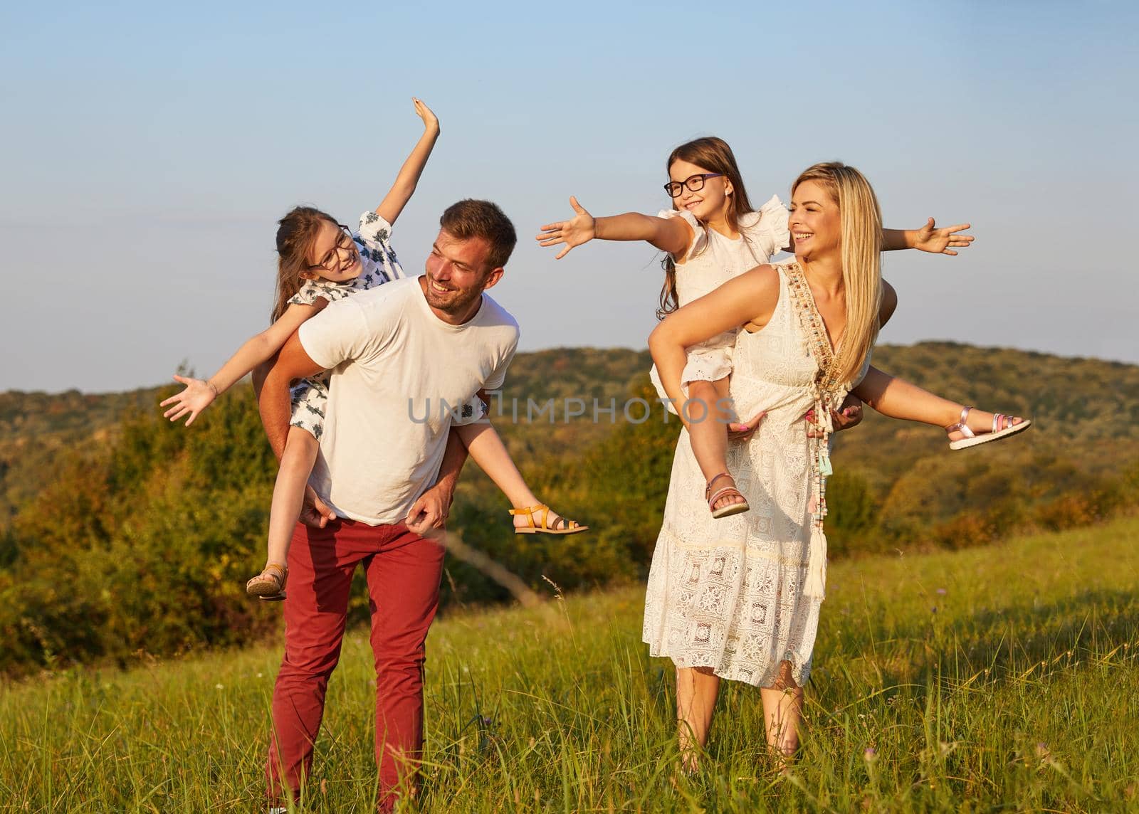 child family outdoor mother woman father girl happy happiness lifestyle having fun bonding piggyback by Picsfive