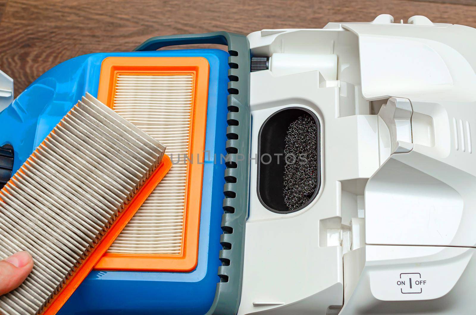 Vacuum cleaner filter with water filter. Large white vacuum cleaner on a brown floor