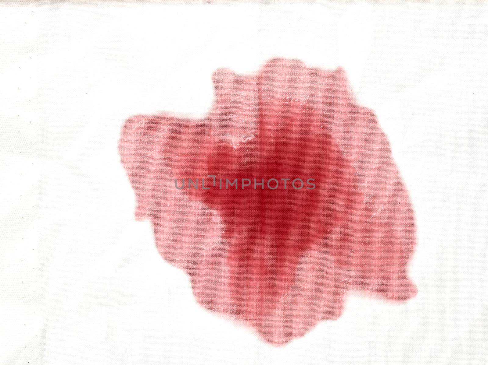 close up of a wine stain spilled on white background