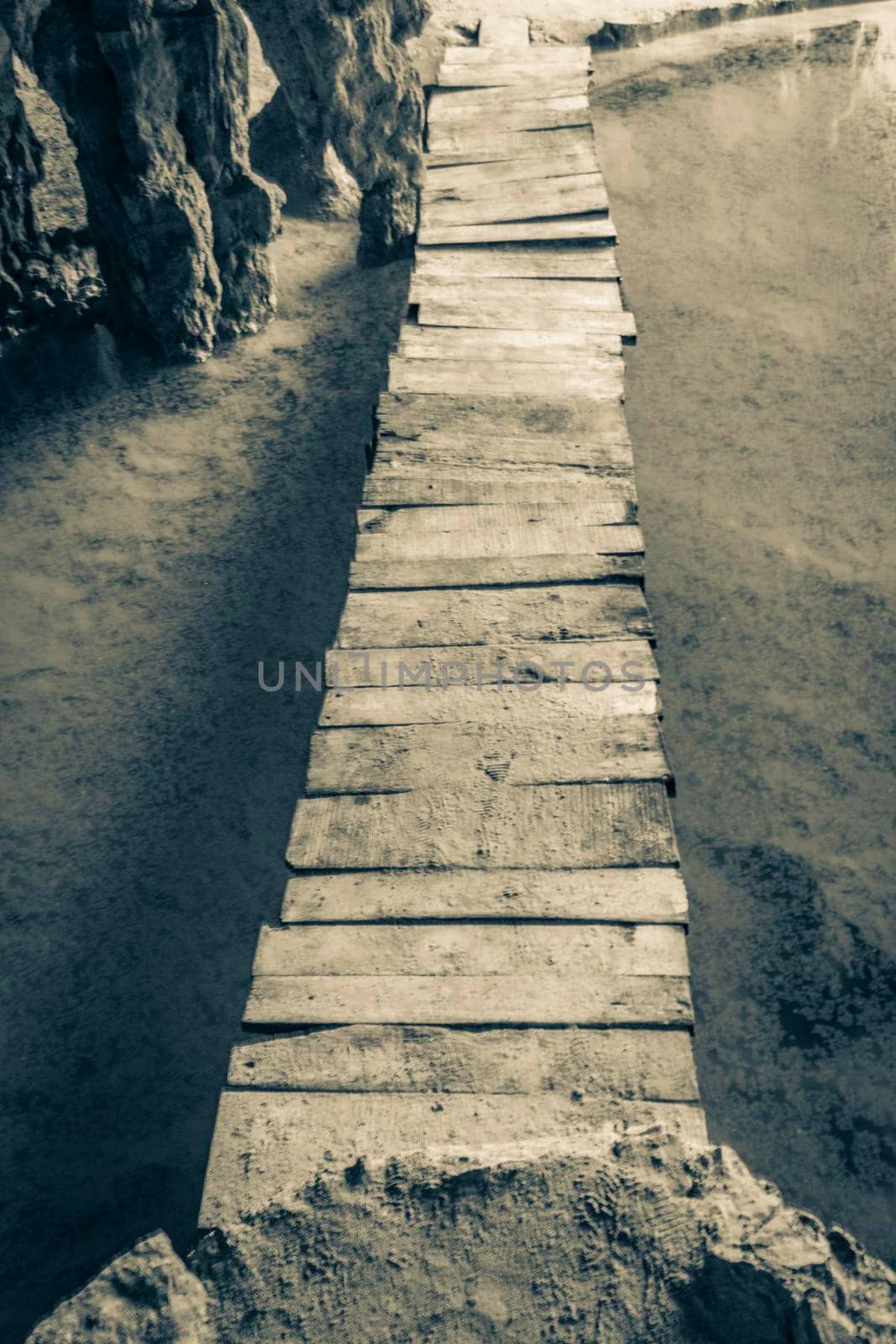 Old black and white picture of Amazing blue turquoise water and limestone cave sinkhole cenote at Santuario de los guerreros in Puerto Aventuras Quintana Roo Mexico.