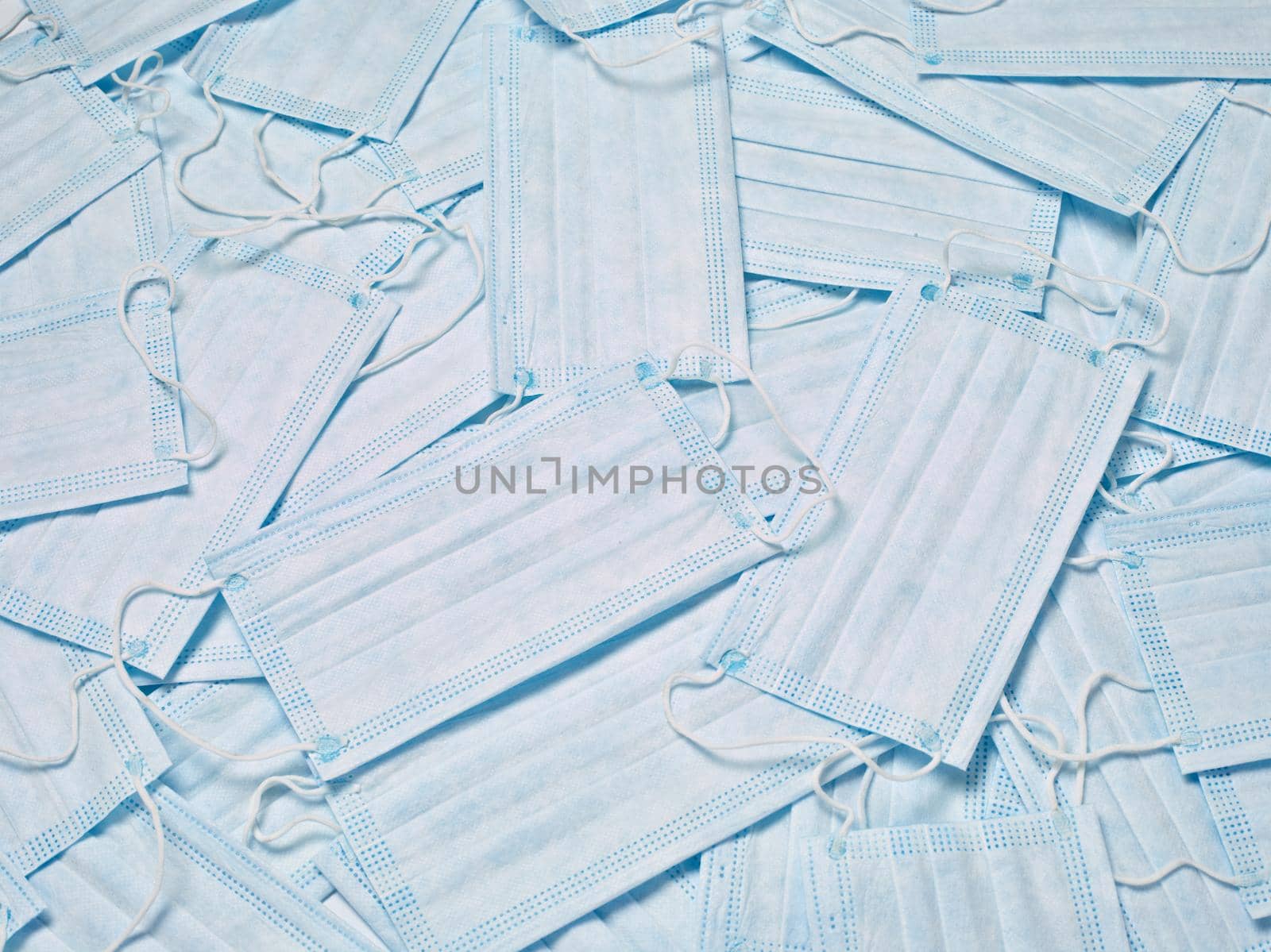 close up of a stack of protective masks on white background