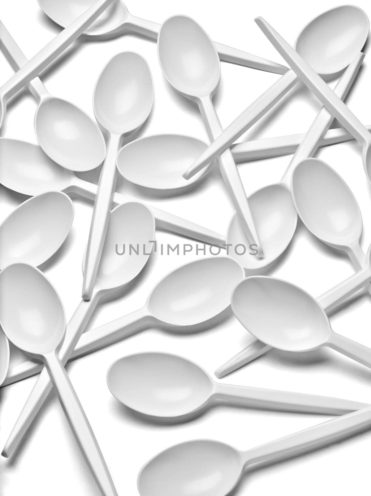 close up of a plastic cutlery spoons on white background