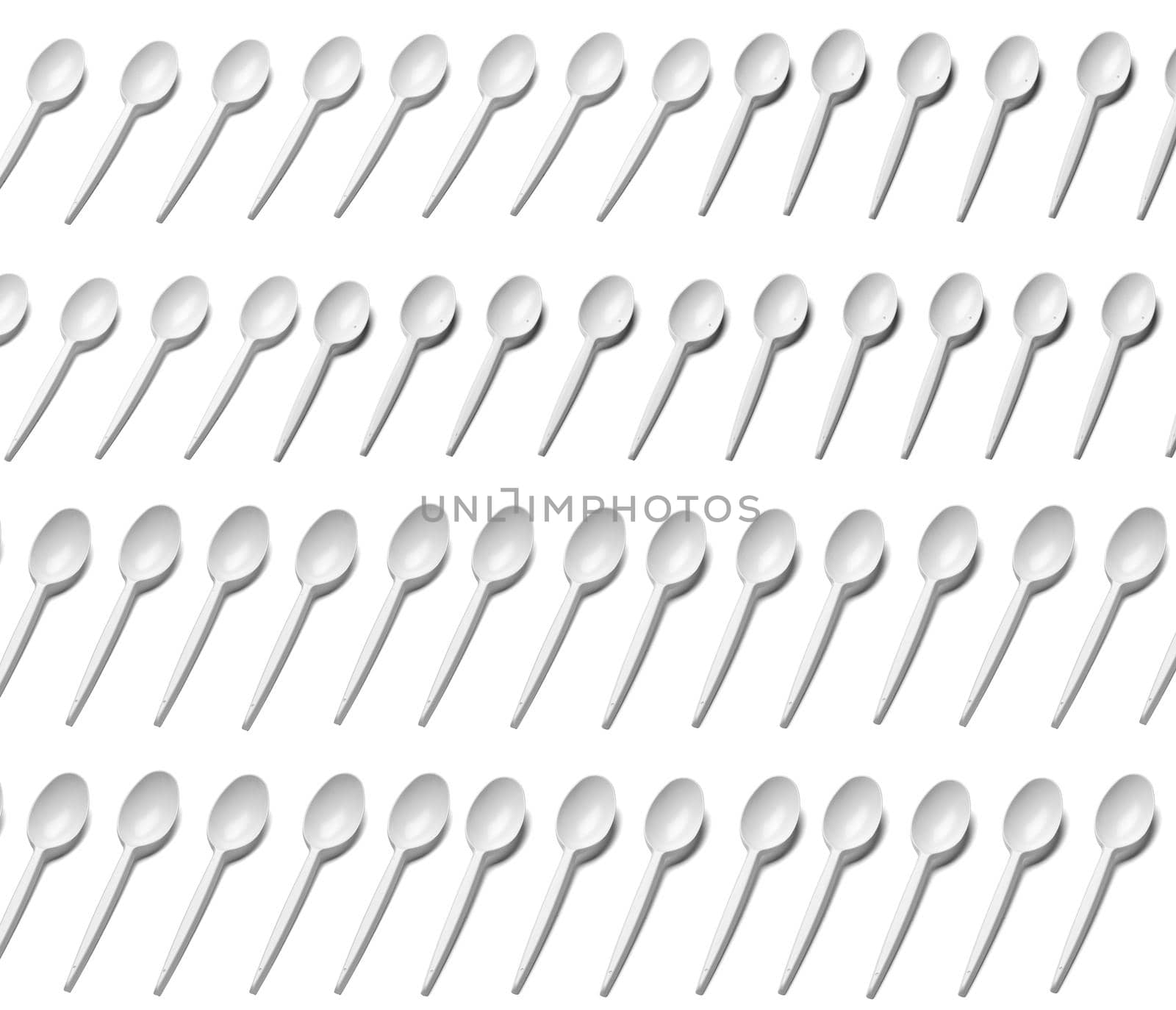 close up of a plastic cutlery spoons on white background