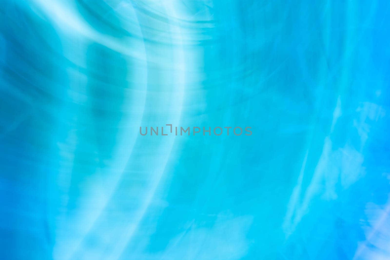 Blue abstract background with gently blurred chaotic white lines waves. Backdrop