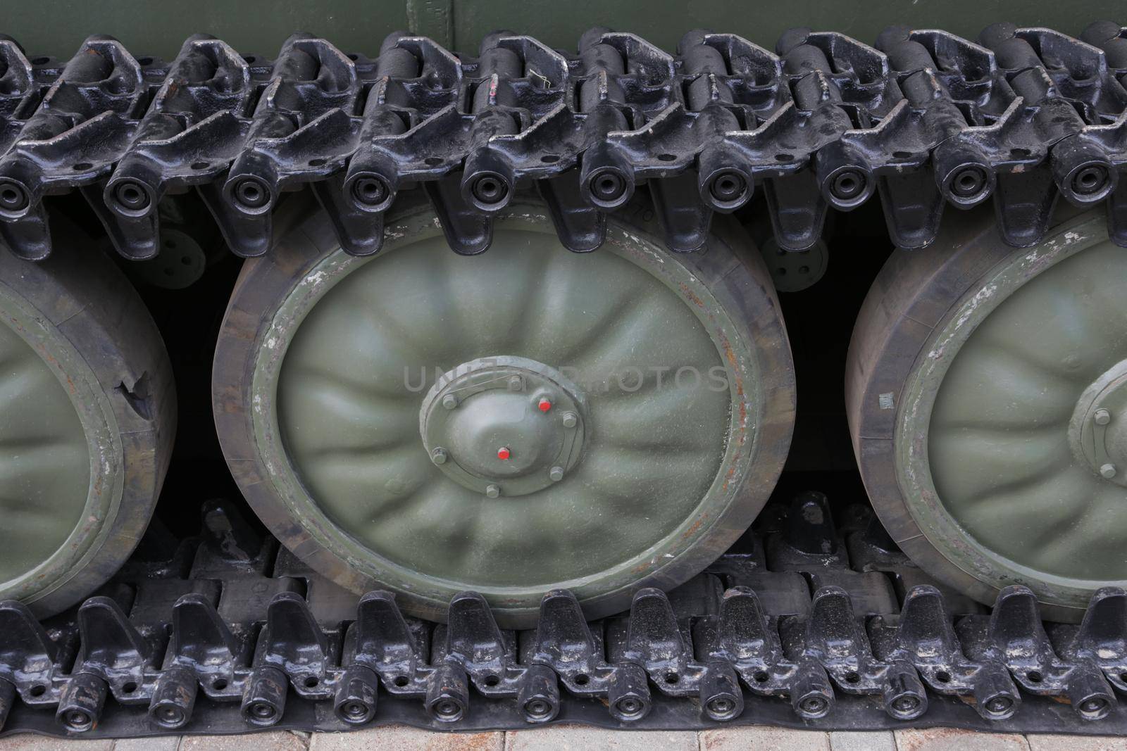 close up of old military tank wheel on caterpillar tracks. by gelog67