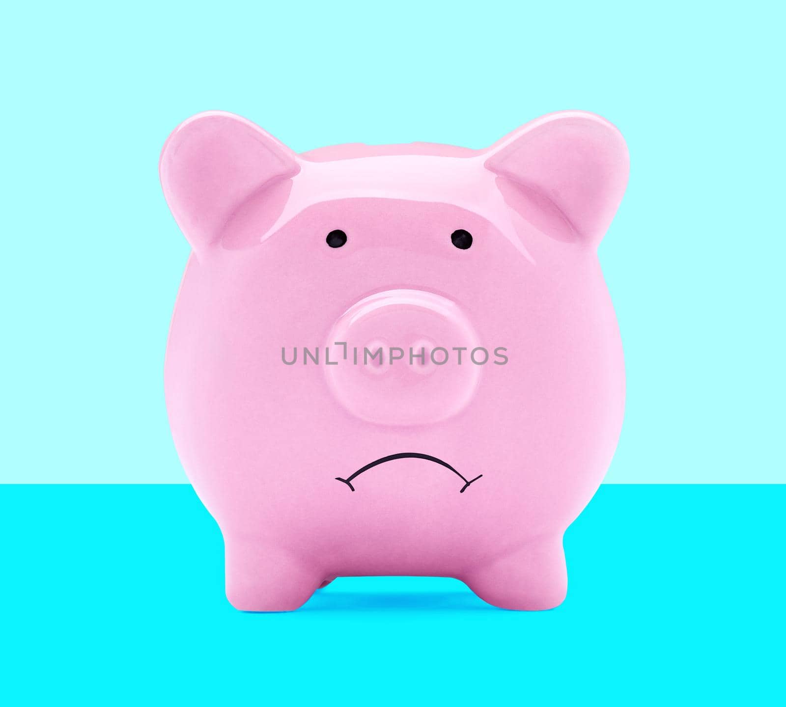 Close up of a sad pink piggy bank on white background