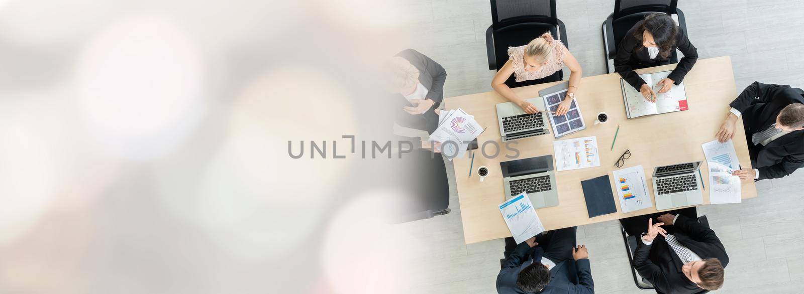 Business people group meeting shot from top widen view in office . Profession businesswomen, businessmen and office workers working in team conference with project planning document on meeting table .