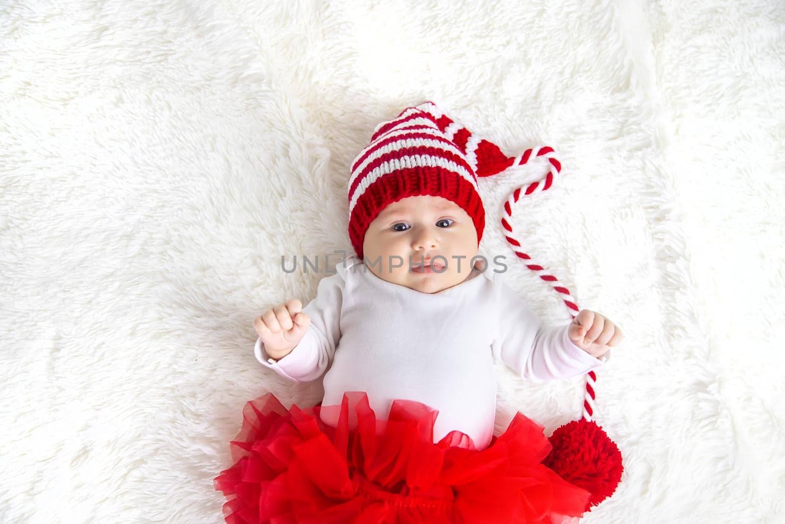 Baby dressed as Santa Claus. Christmas. Selective focus. People.