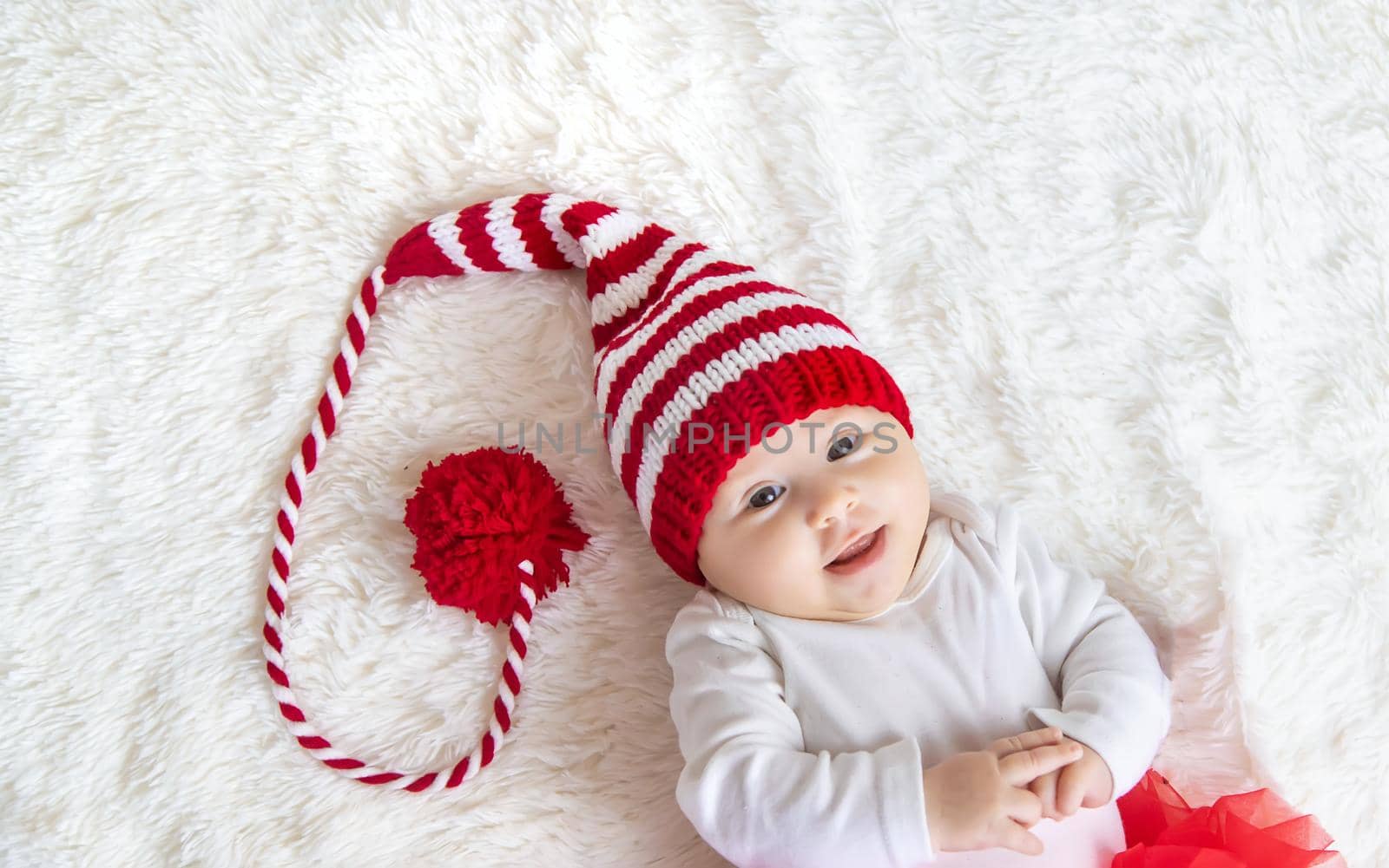 Baby dressed as Santa Claus. Christmas. Selective focus. People.