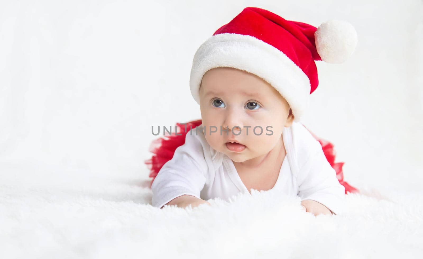 Baby dressed as Santa Claus. Christmas. Selective focus. People.