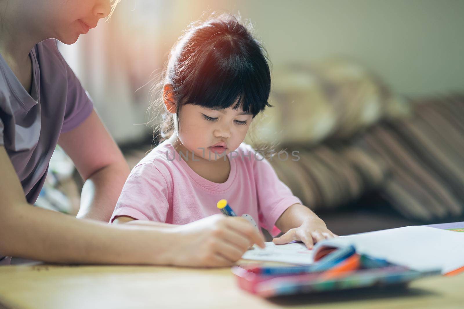 Cute little child painting with colorful paints. Asian girl and her mother using crayon drawing color.Baby artist activity lifestyle concept. by Wmpix