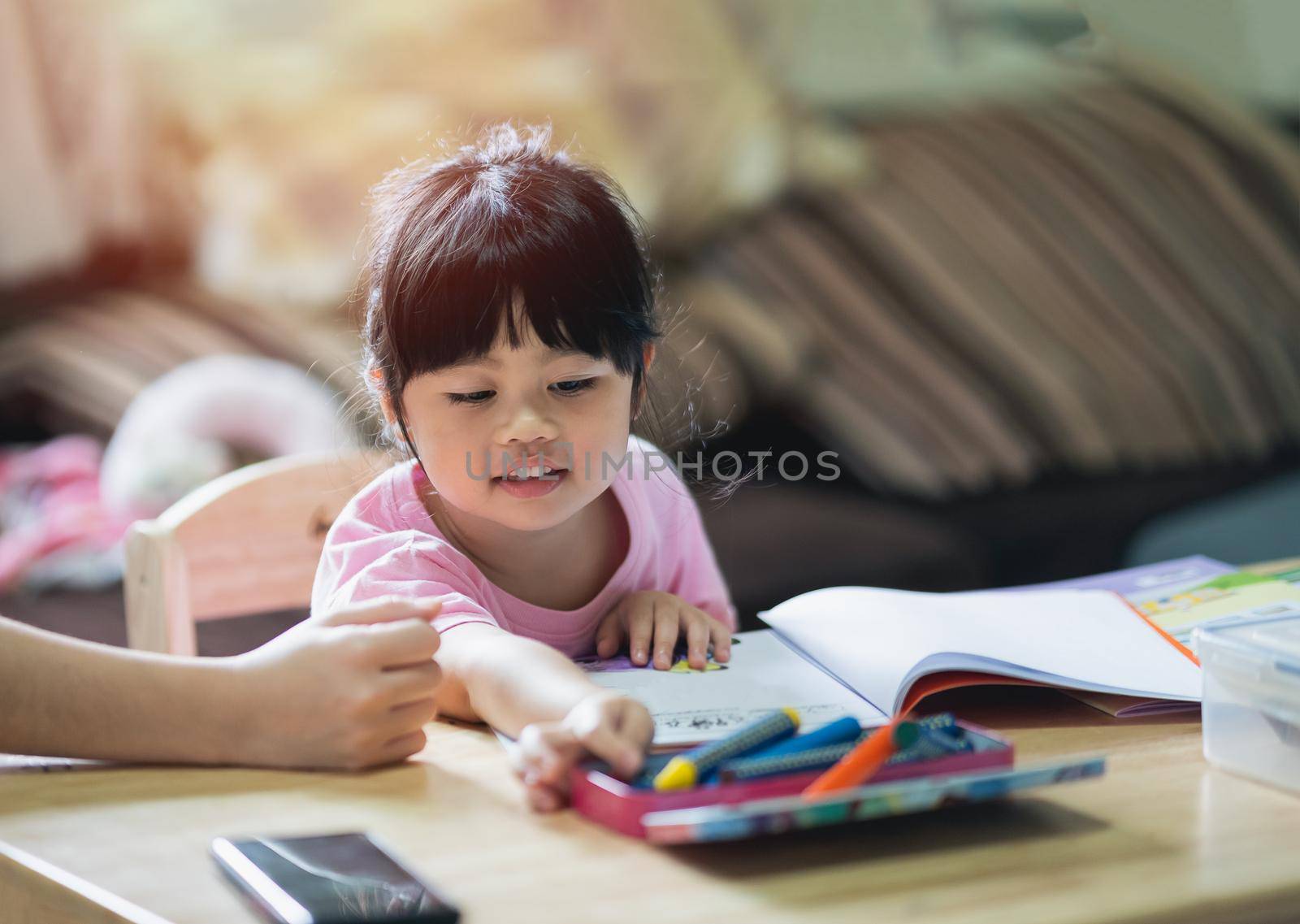 Cute little child painting with colorful paints. Asian girl and her mother using crayon drawing color.Baby artist activity lifestyle concept.